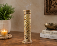 Load image into Gallery viewer, Decorative incense burner on a table with a candle and books in the background

